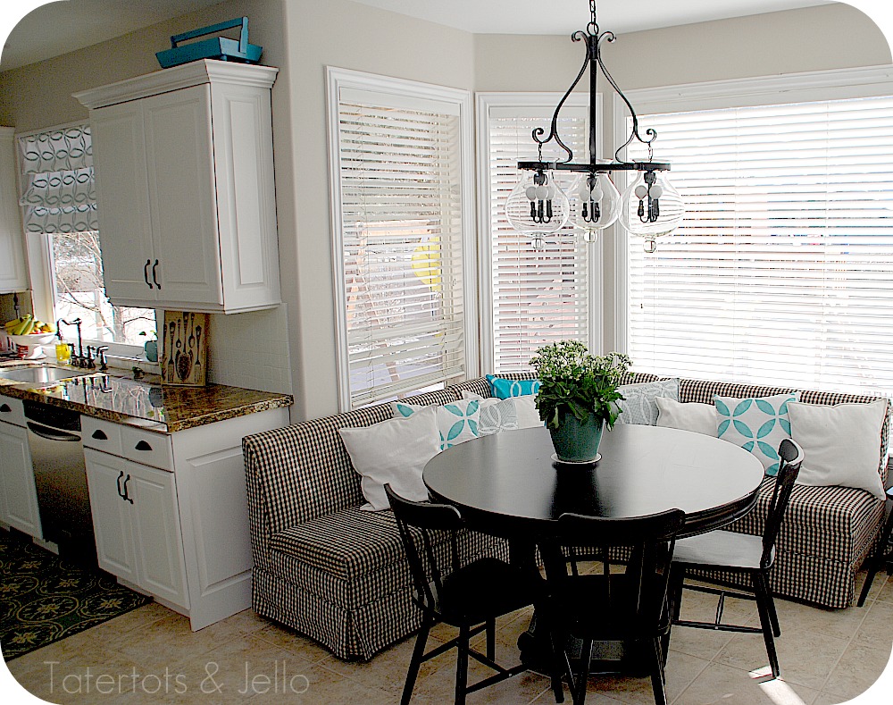 Colorful Summer Farmhouse Kitchen Nook. Turn a corner of your kitchen into a colorful nook with bright summer elements, pillows and a DIY Summer banner! ﻿