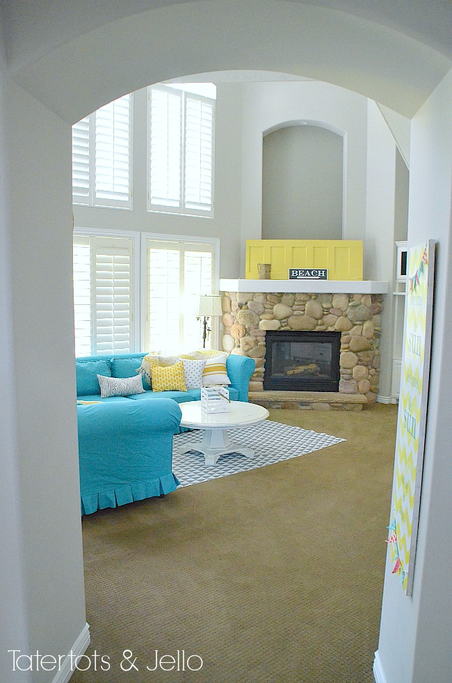 turquoise slipcover and yellow mantel door