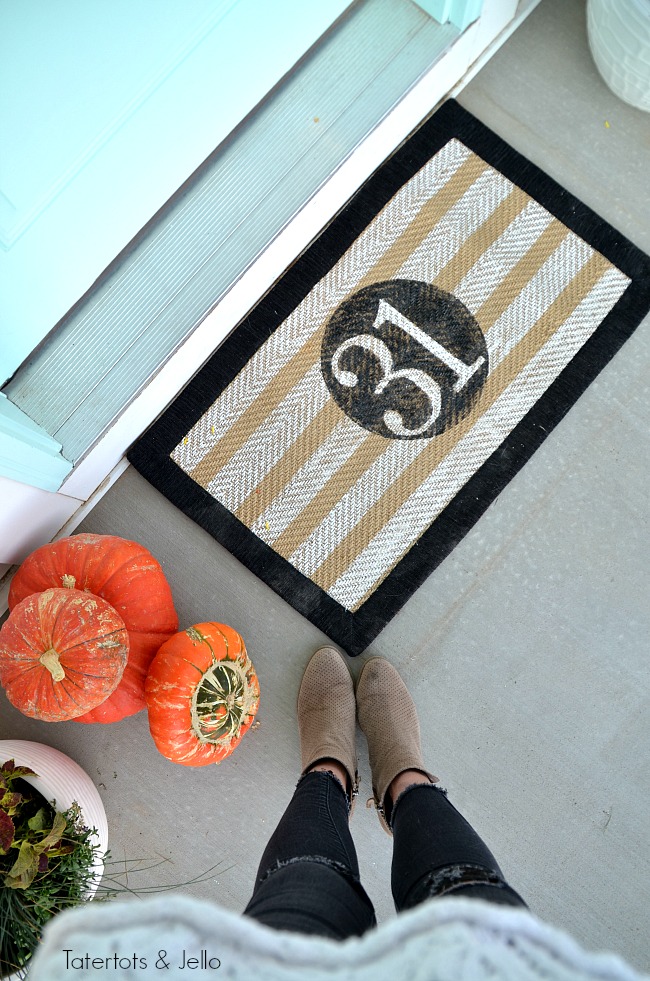 halloween porch stencilled rug. Create a witch theme for your halloween home decor this year with a DIY sign, hanging hats and other spooky ideas!