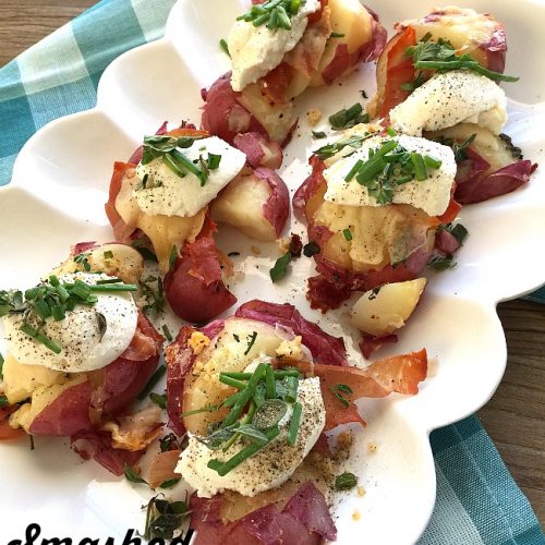 Smashed Parmesan Potatoes with Herbs, Prosciutto and Ricotta. A twist on the popular smashed potatoes, the salty addition of prosciutto and creamy ricotta cheese add delicious dimension to this beautiful side dish!