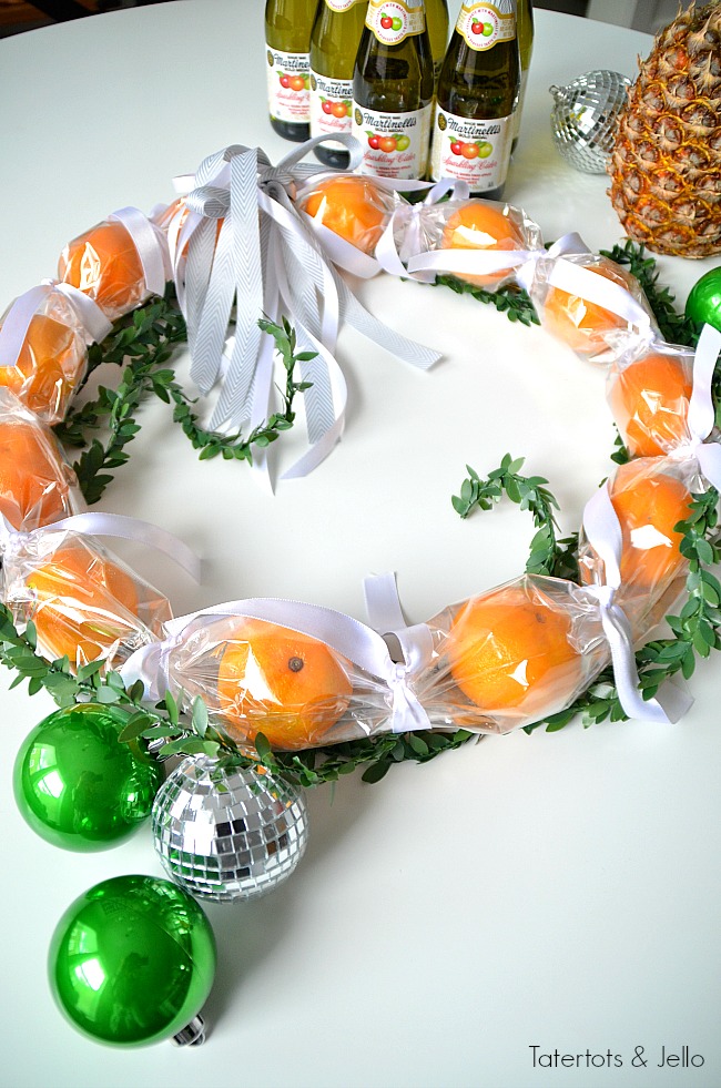 Cuties Wreath Hostess Gift Idea. Use cellophane to create a cuties wreath. It's edible and perfect to give as a neighbor or hostess gift this holiday season! 