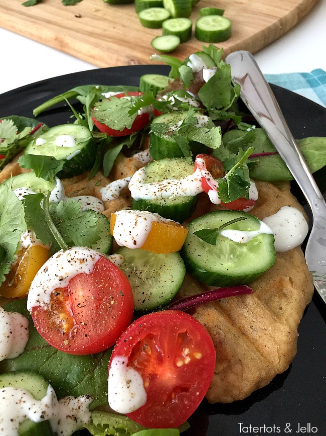 Savory Falafel Waffles are a savory dinner idea. Warm and savory waffles that taste like falafels are surrounded by a cool salad and tangy yogurt dressing. 