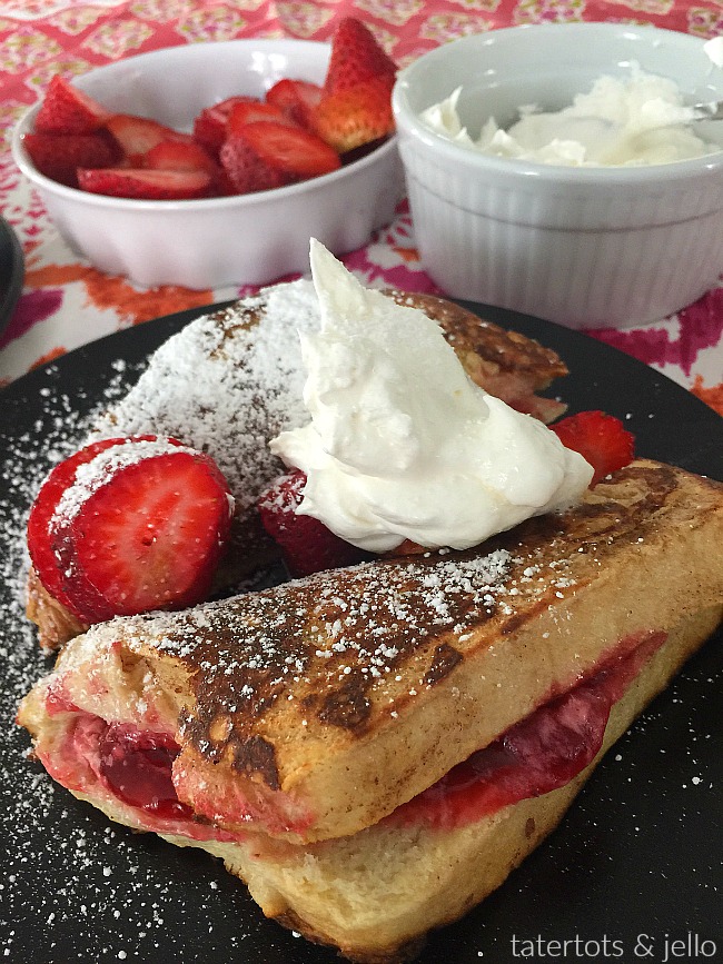 Strawberry Stuffed French Toast. Creamy strawberry filling dipped in almnd egg batter and baked to golden perfection is perfect for Father's Day! 
