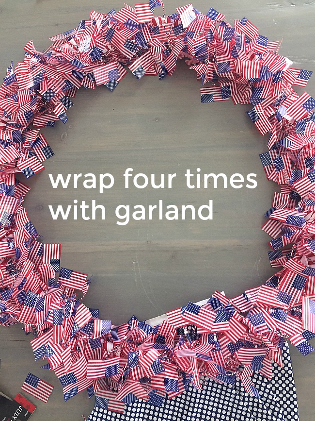 Patriotic Flag Wreath Tutorial. Make a red white and blue flag wreath with inexpensive flag garlands. Easy patriotic wreath tutorial to make your door SHINE for The Fourth! 
