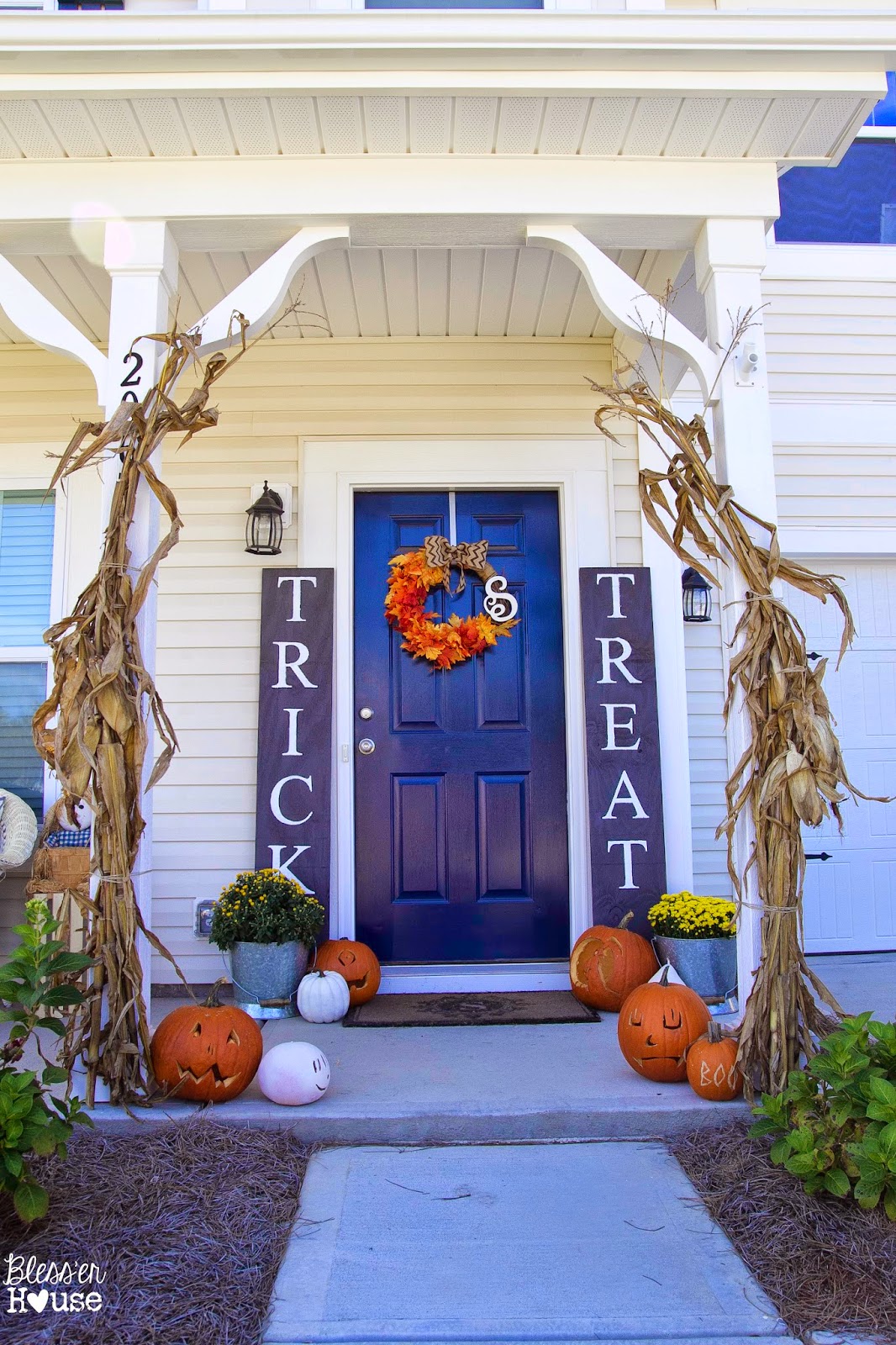 Fall porch with giant trick or treat signs at Blesser House 