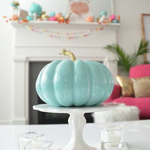 Colorful Fall Mantel with Painted Foam Pumpkins. Paint inexpensive pumpkins bright colors for a unexpected colorful fall mantel!