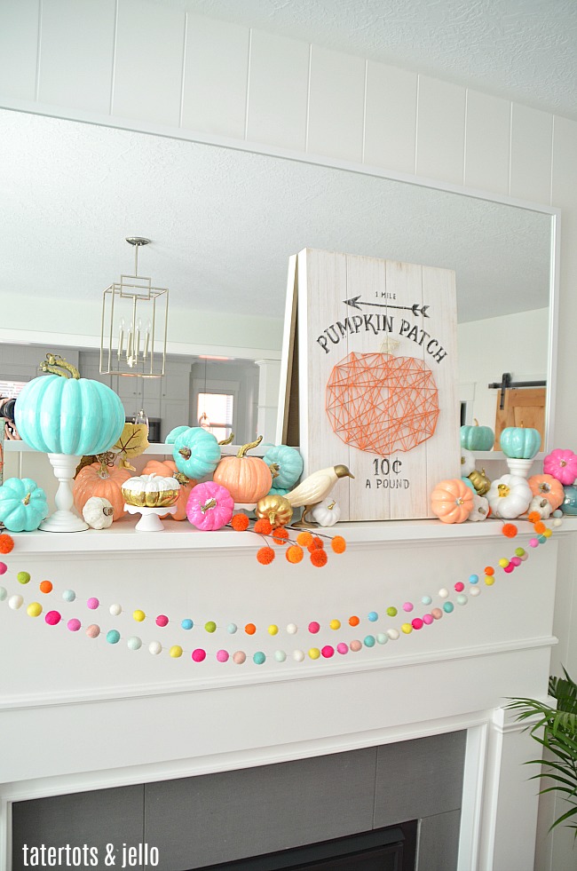 Colorful Fall Mantel with Painted Foam Pumpkins. Paint inexpensive pumpkins bright colors for a unexpected colorful fall mantel!