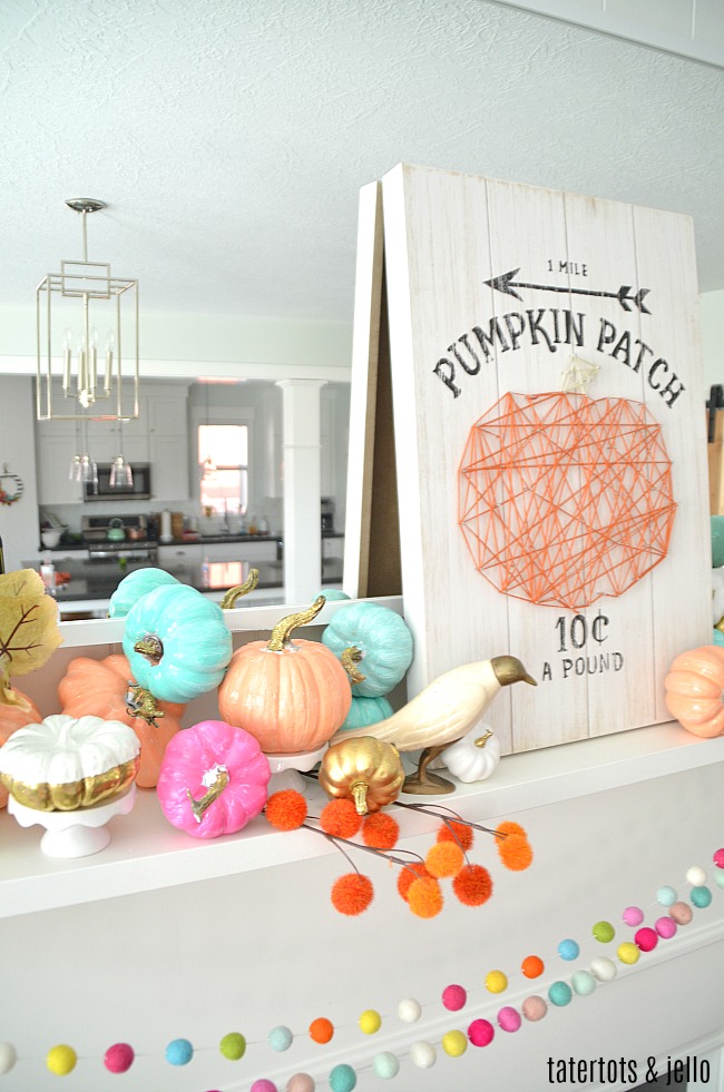 Colorful Fall Mantel with Painted Foam Pumpkins. Paint inexpensive pumpkins bright colors for a unexpected colorful fall mantel!