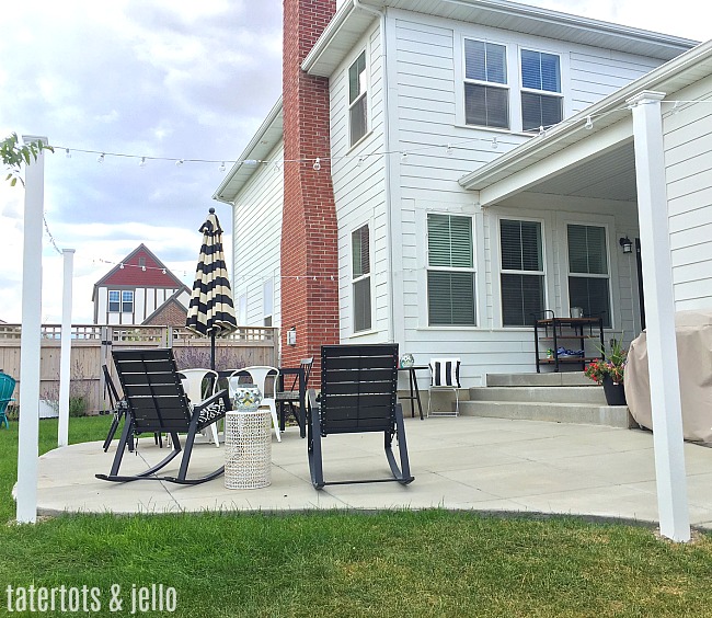 1 hour modern cafe light patio project. Use vinyl fence posts to create a modern way to display cafe lights in your yard.