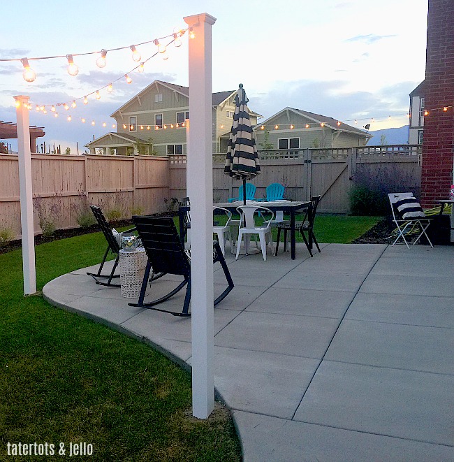 1 hour modern cafe light patio project. Use vinyl fence posts to create a modern way to display cafe lights in your yard. 