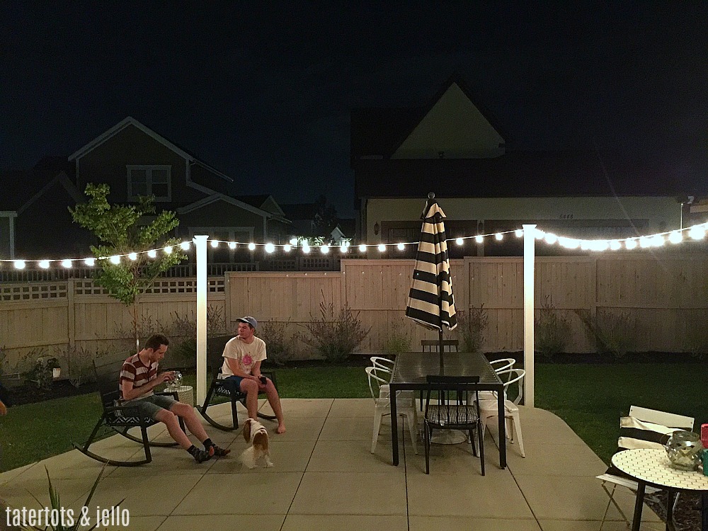 1 hour modern cafe light patio project. Use vinyl fence posts to create a modern way to display cafe lights in your yard. 