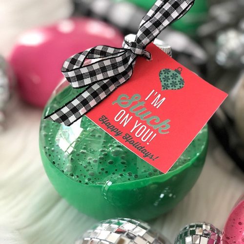 Holiday Slime Ornaments - your kids will love making this glittery slime and giving it to their friends in kid-friendly big plastic ornaments with a special gift tag!