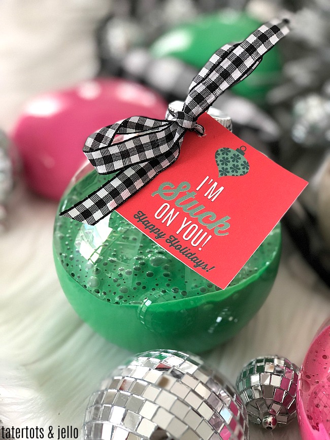 Holiday Slime Ornaments - your kids will love making this glittery slime and giving it to their friends in kid-friendly big plastic ornaments with a special gift tag!