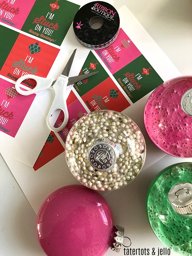 Holiday Slime Ornaments - your kids will love making this glittery slime and giving it to their friends in kid-friendly big plastic ornaments with a special gift tag! 