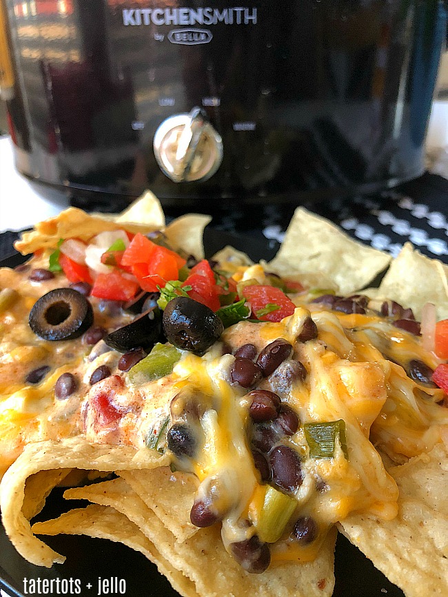 Game Day Warm Crock-pot 7-layer dip - all of the delicious layers blend together in your Crock-pot to create the PERFECT hot dip to serve! 