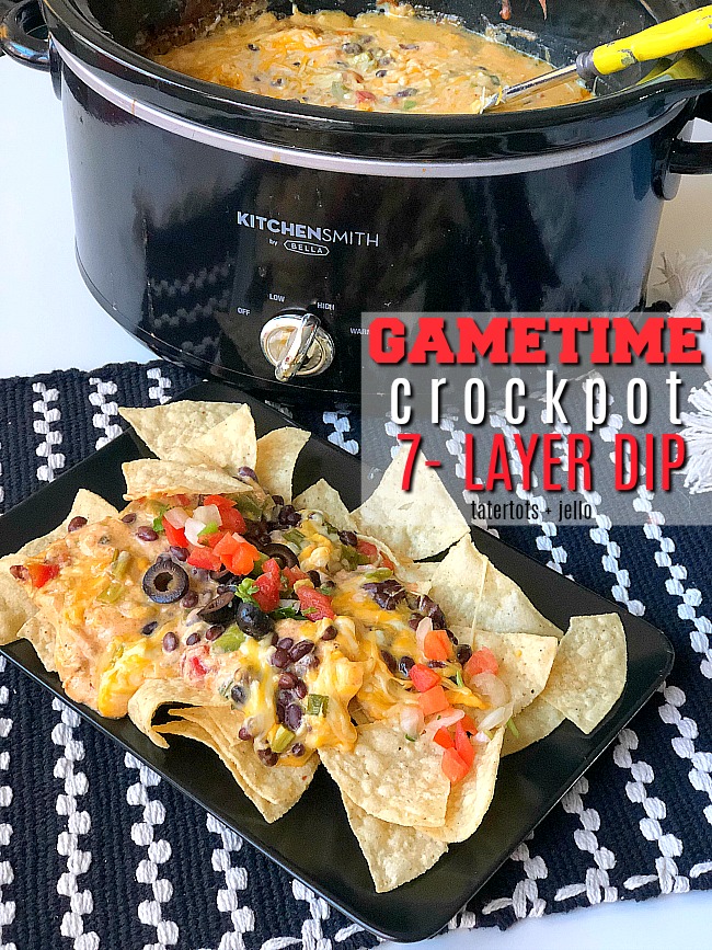 Game Day Warm Crock-pot 7-layer dip - all of the delicious layers blend together in your Crock-pot to create the PERFECT hot dip to serve!