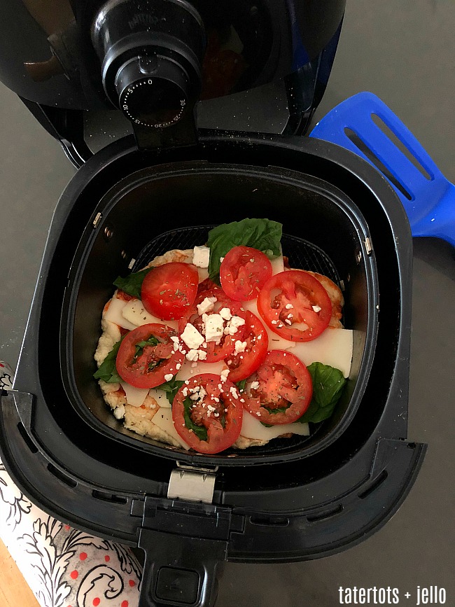 Airfry Pizza Party - kids will love making personalized pizzas. Have everyone make theirs and then cook them in the airfryer. It only takes a few minutes for a perfectly crispy pizza! 