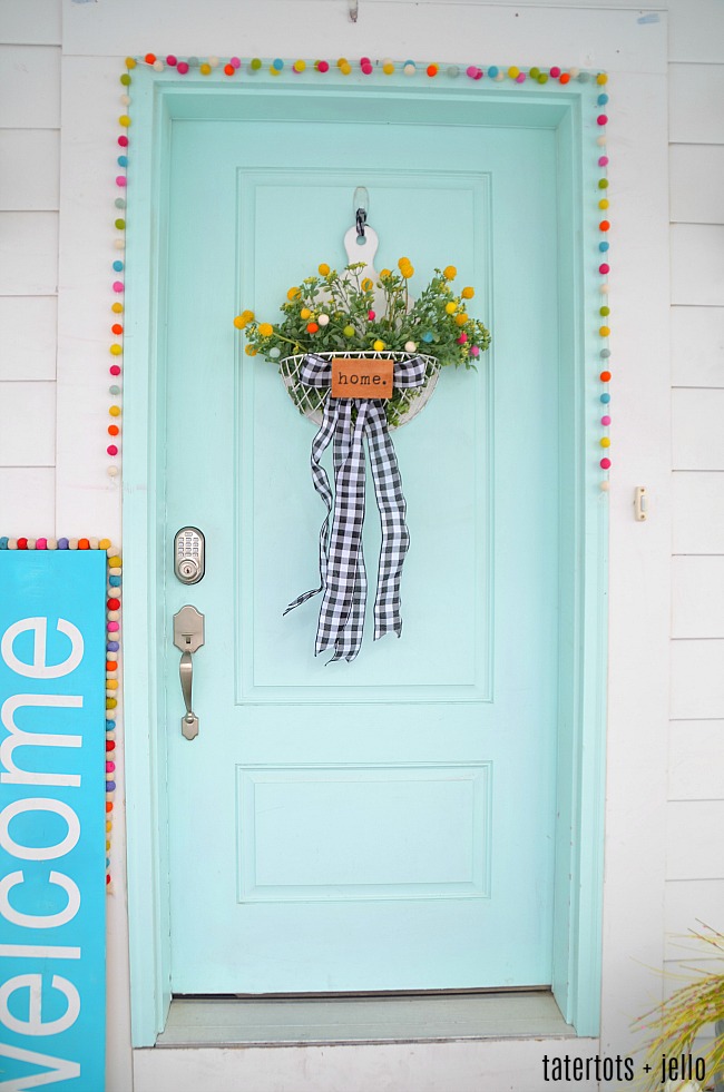 Spring Farmhouse Pom Pom Wreath - turn a wood organizer into a whimsical farmhouse wreath for your door! 