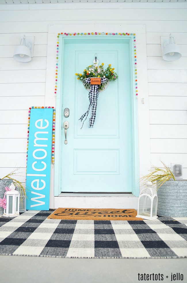 Spring Farmhouse Pom Pom Wreath - turn a wood organizer into a whimsical farmhouse wreath for your door! 