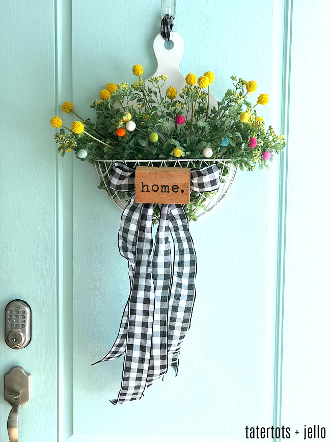 Spring Farmhouse Pom Pom Wreath - turn a wood organizer into a whimsical farmhouse wreath for your door! 