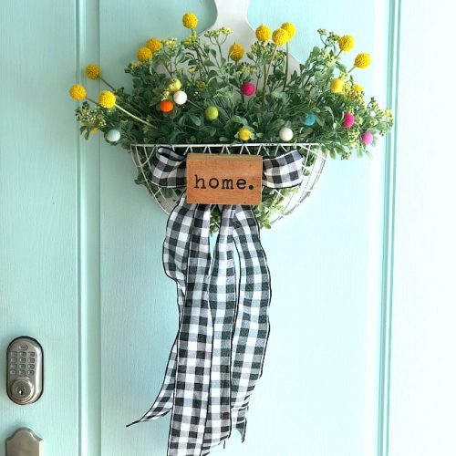 Spring Farmhouse Pom Pom Wreath - turn a wood organizer into a whimsical farmhouse wreath for your door!