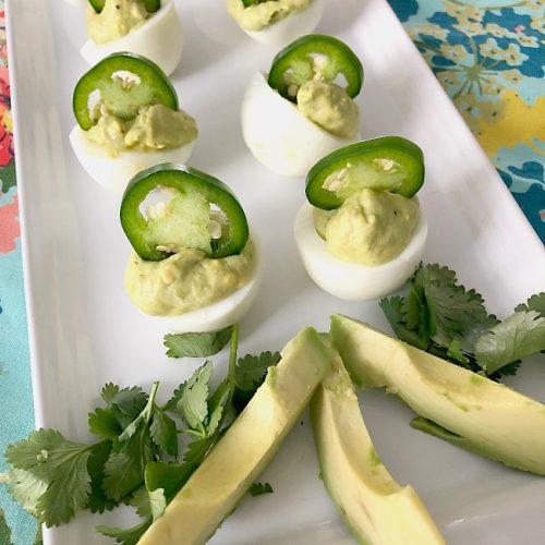 Spicy Avocado Eggs are a zesty twist on traditional deviled eggs. Filled with creamy avocado and egg yolks, plus spiced and topped with sliced jalapenos, these eggs will be the star of your spring brunch!