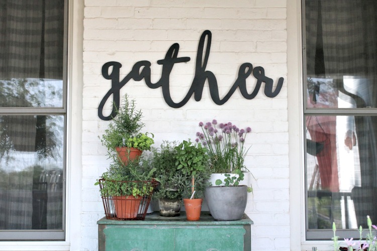 Spring  porch with garden and wood sign.