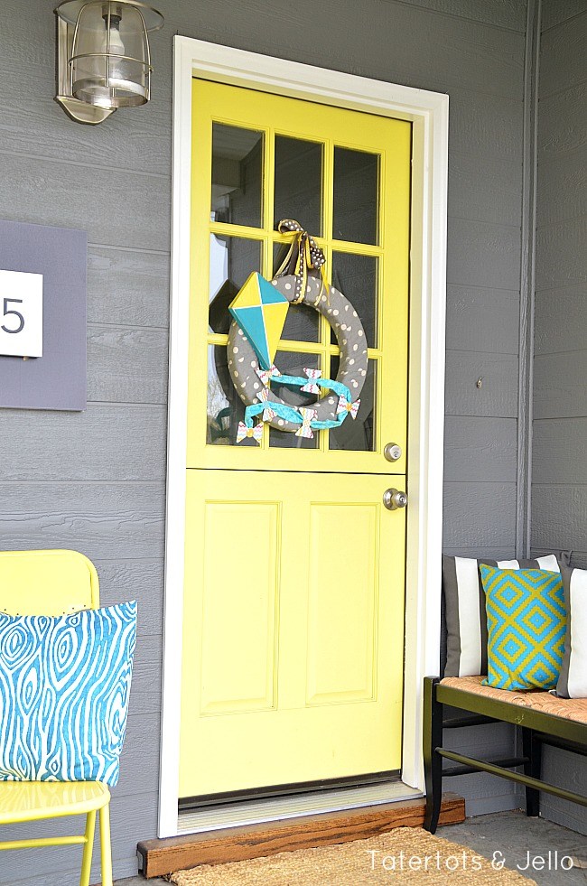 Spring porch with let's fly a kite wreath.