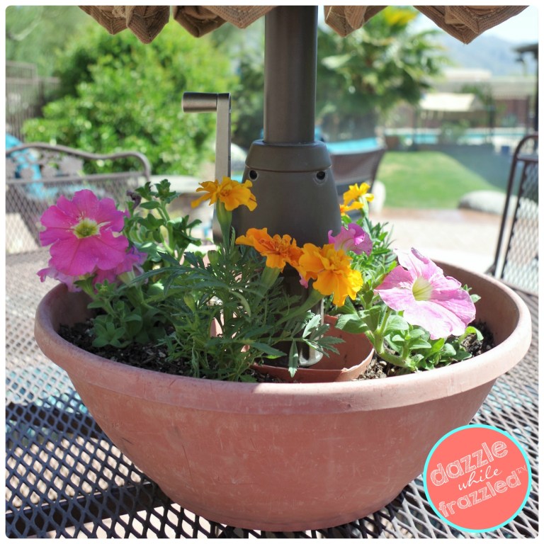 18 DIY Spring Home Ideas! How to make a terra cotta pot that holds flowers around your outdoor patio umbrella.