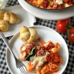 Basil Chicken Gnocchi Skillet Bake. Layers of basil pasta sauce, creamy gnocchi, crisp breaded chicken, fresh basil and gooey cheese are baked for a hearty Italian dish everyone loves! Add buttery garlic knots that you bake in the bag and are perfect for busy families and a and beautiful dish you can serve to your family or to wow visitors! 