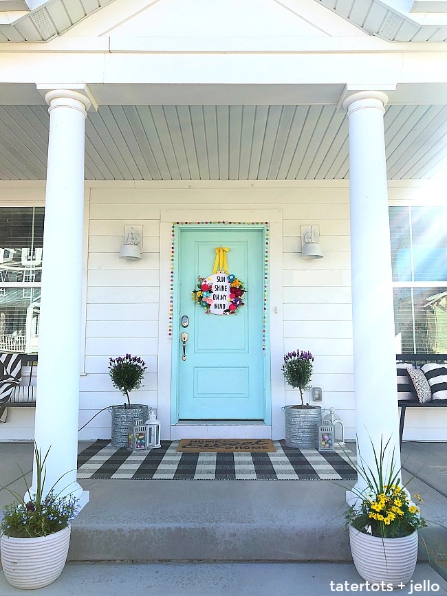 How to make a felt flower hoop saying wreath. Create a saying for spring and put it inside an embroidery wreath with felt flowers. It's fun to make and will welcome visitors to your home all summer long! 