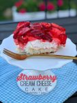 The BEST  Fresh Strawberry Cream Cheese Cake Recipe. Moist white cake covered in a fluffy layer of cream cheese and whipped cream with a topping of luscious fresh strawberries in a sweet strawberry glaze. Everyone will fall in love with this delicious, easy cake.  