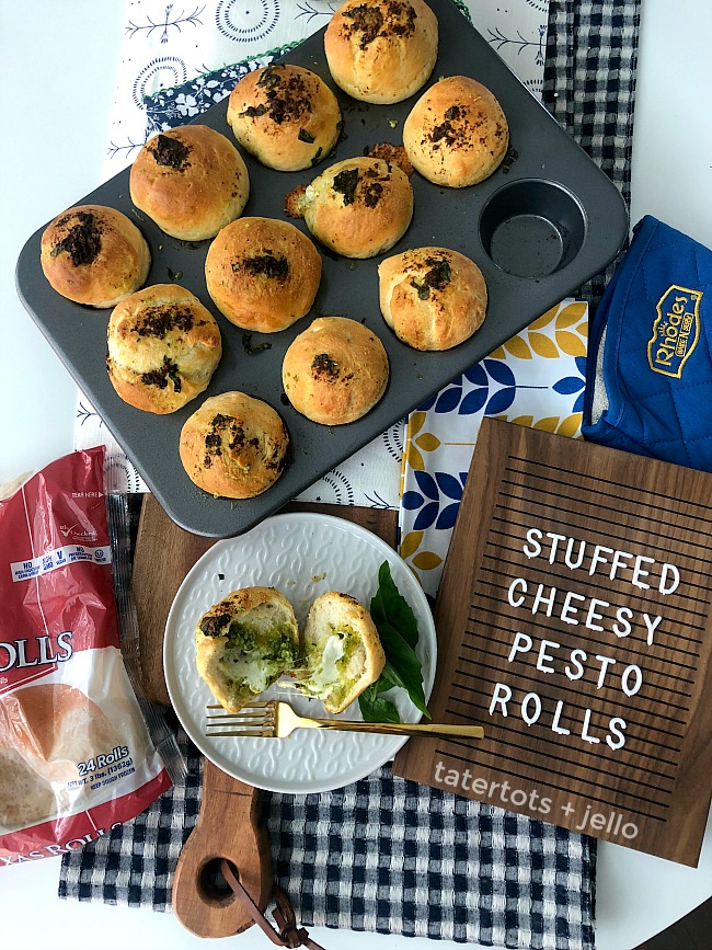 Stuffed Cheesy Mozzarella Pesto Rolls are an easy recipe to whip up using pre-made dough. Warm fragrant rolls are stuffed with gooey mozarella and parmesan cheese, pesto and basil. It's the perfect compliment to an Italian Dinner OR a great lunch on it's own! 