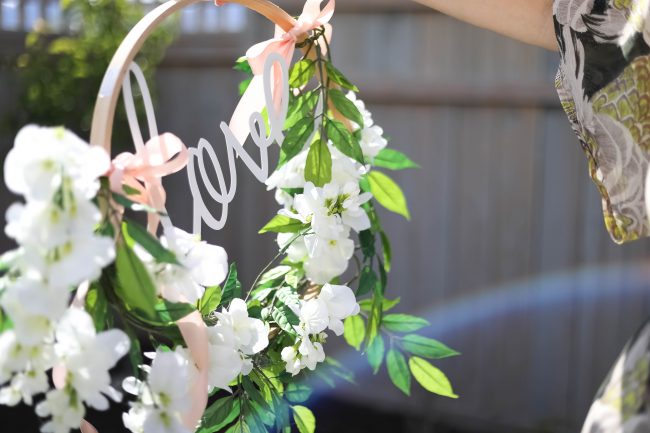 Make a DIY Magnolia Garden Wreath for Summer. All it takes is a few materials and in less than 15 minutes you will have a beautiful wreath to hang on your door or wall! 