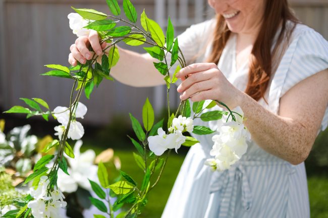 Make a DIY Magnolia Garden Wreath for Summer. All it takes is a few materials and in less than 15 minutes you will have a beautiful wreath to hang on your door or wall! 