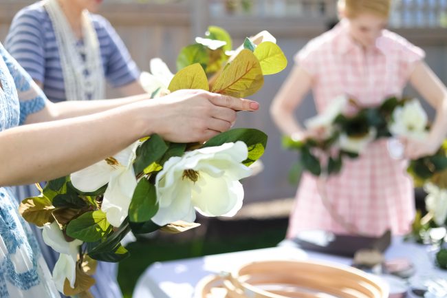 Make a DIY Magnolia Garden Wreath for Summer. All it takes is a few materials and in less than 15 minutes you will have a beautiful wreath to hang on your door or wall! 