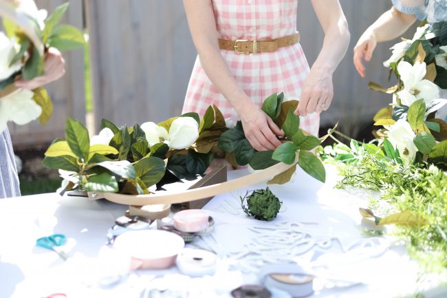 Make a DIY Magnolia Garden Wreath for Summer. All it takes is a few materials and in less than 15 minutes you will have a beautiful wreath to hang on your door or wall! 