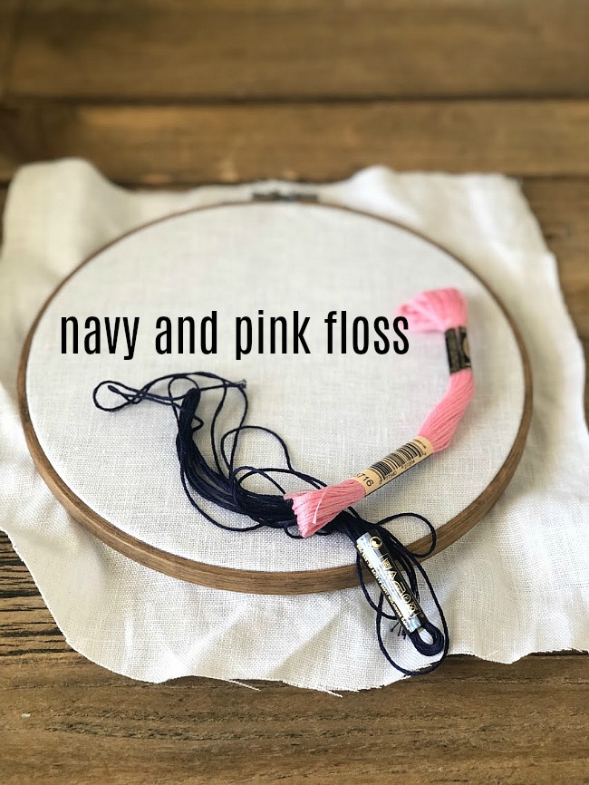Make an embroidery hoop wall hanging. A hand-stitched word is surrounded by vibrant paper flowers in an embroidery hoop. Make one for your home or to give as a gift! 