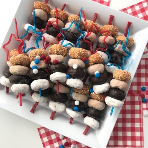 Fourth of July MIni Donut Skewers are a really easy dessert to make for a BBQ, picnic or get-together. Mini Donuts are threaded onto red licorice for a really easy and festive dessert that kids love! You can make this in minutes and kids love them! 