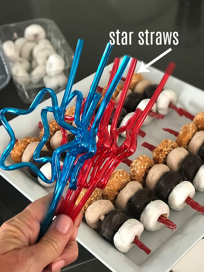 Fourth of July MIni Donut Skewers are a really easy dessert to make for a BBQ, picnic or get-together. Mini Donuts are threaded onto red licorice for a really easy and festive dessert that kids love! You can make this in minutes and kids love them! 