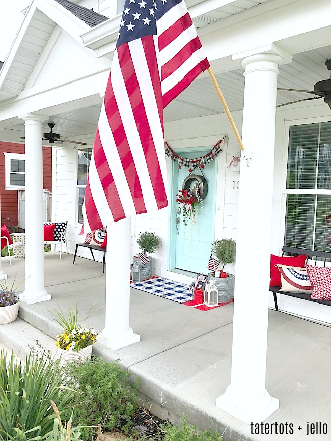 Create a memorable Fourth of July wreath. The galvanized wreath base holds a wooden star surrounded by three flags, a painted 4 and beautiful red and blue flowers and draping greenery. 