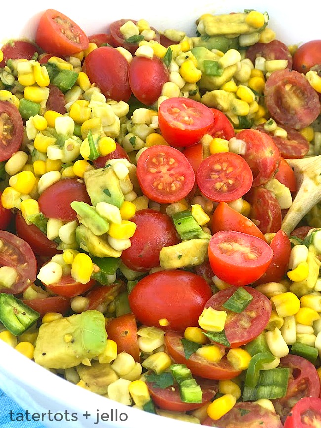 Tangy Corn, Avocado and Tomato Salad. Celebrate the bounties of summer with the perfect trifecta of corn, avocados and tomatoes! Creamy avocado, baby tomatoes and crunchy corn are covered in an zesty citrus lemon olive oil dressing. It's the perfect summertime salad - perfect for dinner or to take to a BBQ or potluck! 