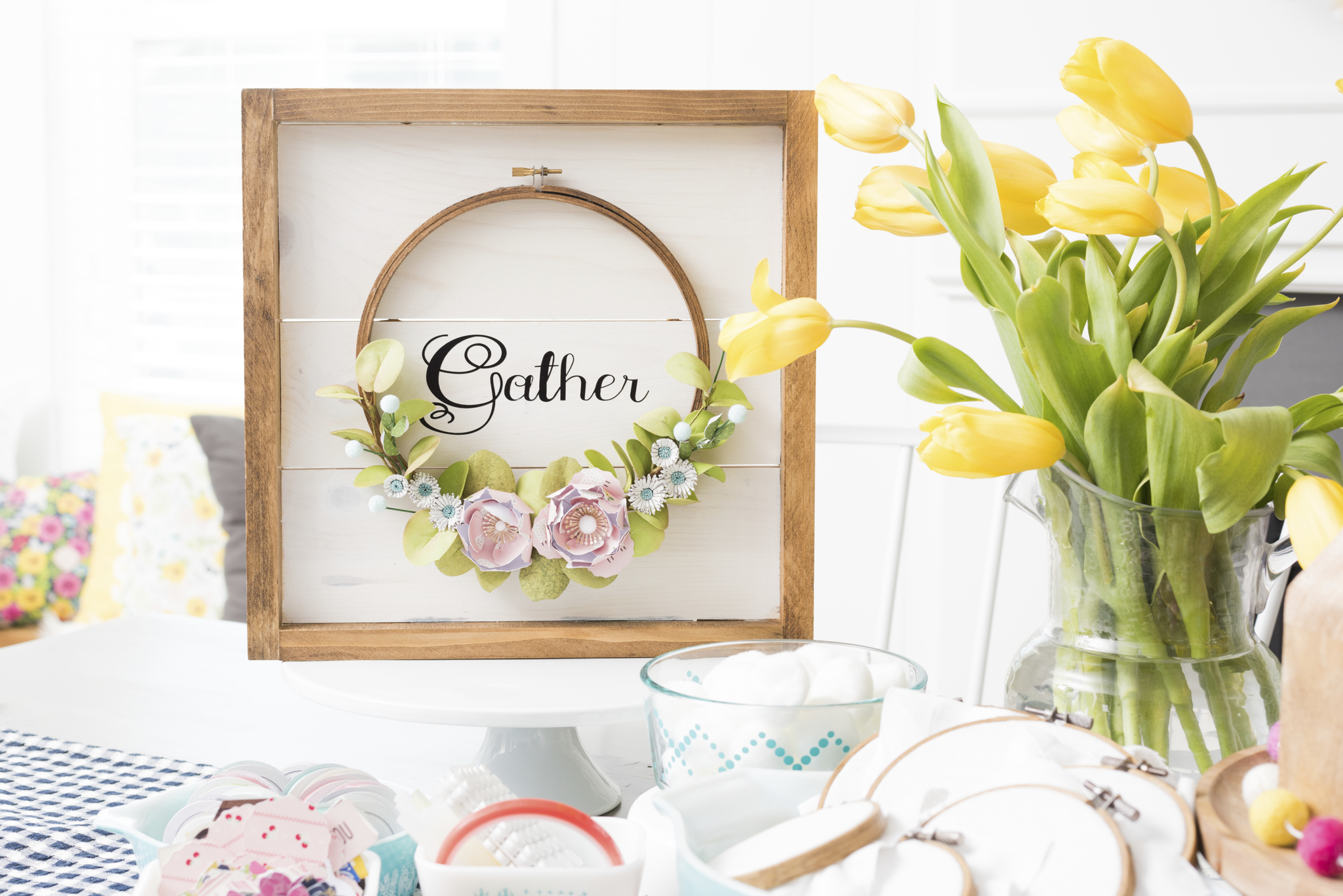 Make an Autumn Framed Embroidery Hoop Gather Wall Hanging. Create a beautiful Fall Wall Hanging with a frame, an embroidery hoop, vinyl letters and paper flowers. Hang it on your front door or a wall to welcome Autumn to your home! 