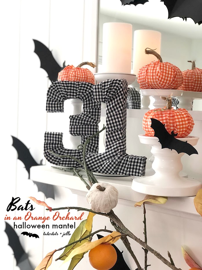 Halloween Bats in an Orange Orchard Mantel. Pumpkins on orange vines, farmhouse signs, decoupaged pumpkins and bats make a bright Halloween mantel with a slightly spooky side! 