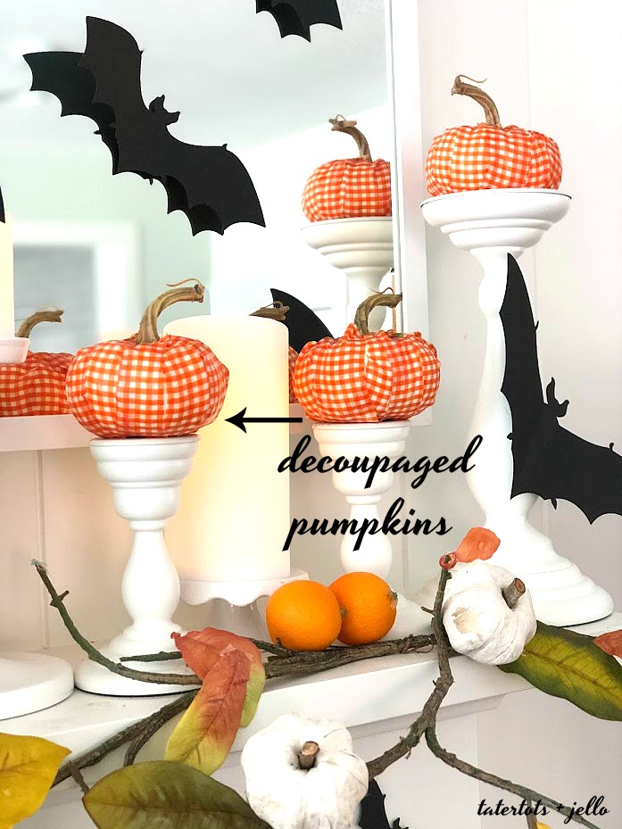 Halloween Bats in an Orange Orchard Mantel. Pumpkins on orange vines, farmhouse signs, decoupaged pumpkins and bats make a bright Halloween mantel with a slightly spooky side! 