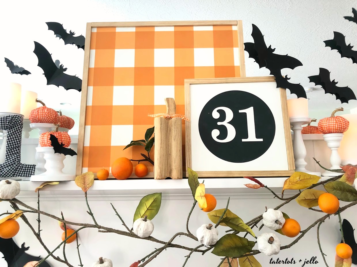 Halloween Bats in an Orange Orchard Mantel. Pumpkins on orange vines, farmhouse signs, decoupaged pumpkins and bats make a bright Halloween mantel with a slightly spooky side! 