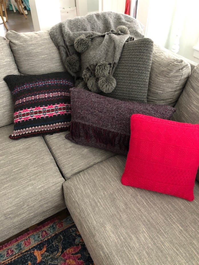 How to make Fall pillows out of thrifted sweaters! Repurpose old sweaters into new and vibrant pillow covers for your home this fall. This easy sewing tutorial shows you how! 