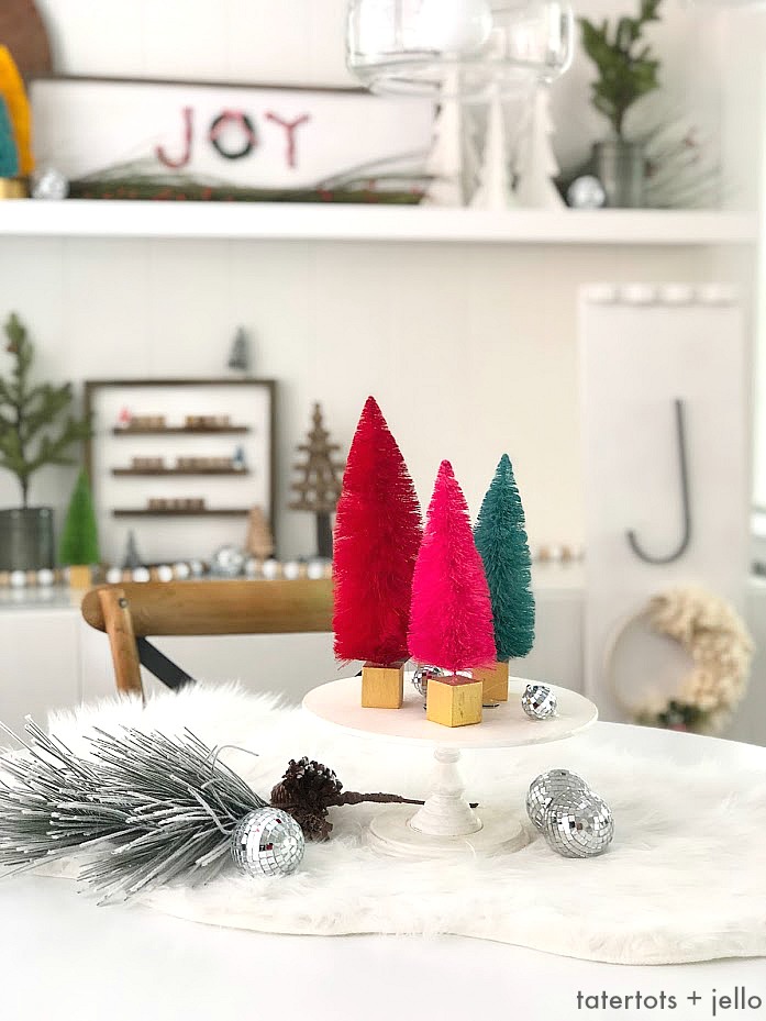 Cozy Christmas Nook Decorating Ideas! Decorate shelves in your kitchen for the holidays with DIY projects, greenery and trees for a welcoming place to gather with your family.