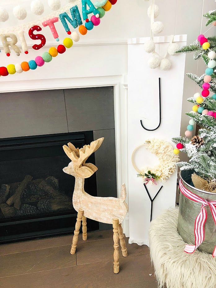 Make a GIANT JOY sign for under $10. An unfinished board, trim, embroidery hoop, yarn, letters and spray paint combine to create something special for the holidays!