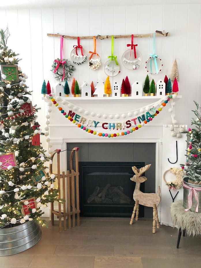 Make a GIANT JOY sign for under $10. An unfinished board, trim, embroidery hoop, yarn, letters and spray paint combine to create something special for the holidays!